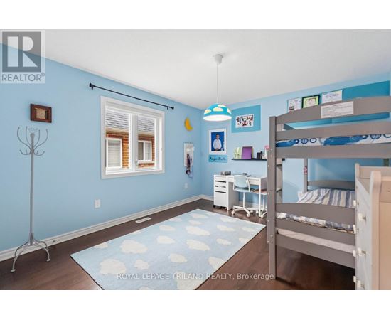 A bedroom with a bunk bed and a desk.