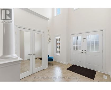A white hallway with a column and a door.