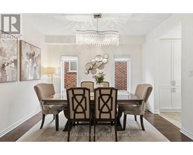 A dining room with a table set for four.