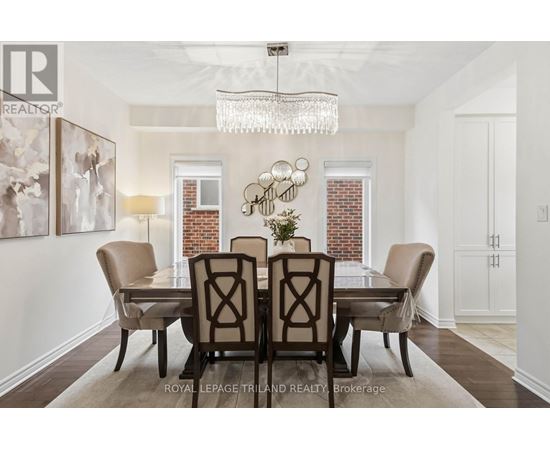 A dining room with a table set for four.