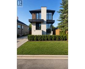 A modern house with a glass window is numbered 43.