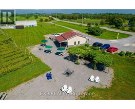 A real estate brokerage office with a parking lot and a few chairs.