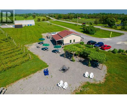 A real estate brokerage office with a parking lot and a few chairs.