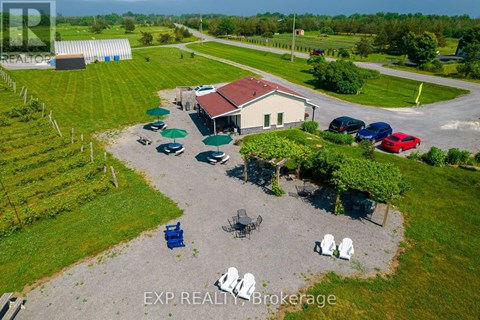 A real estate brokerage office with a parking lot and a few chairs.