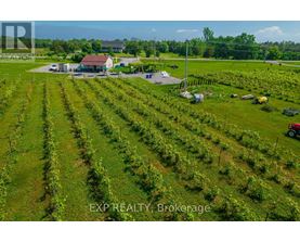 An aerial view of a farm with a house and a tractor.