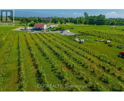 An aerial view of a farm with a house and a tractor.