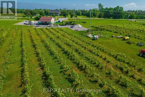 An aerial view of a farm with a house and a tractor.