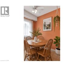 A dining room with a wooden table and chairs.