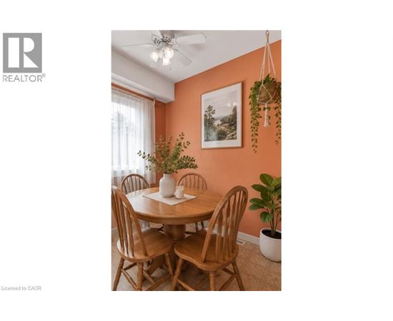 A dining room with a wooden table and chairs.