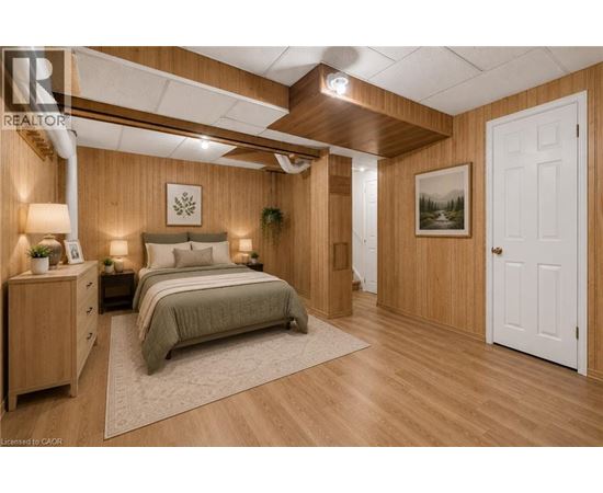 A bedroom with a bed, nightstands, and a painting on the wall.