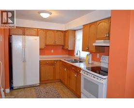 A kitchen with wooden cabinets and a white refrigerator.