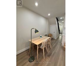 A room with a desk and chairs in it.