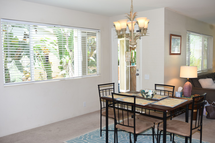 A dining room with a table set for four.