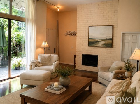 A living room with a fireplace and a painting on the wall.
