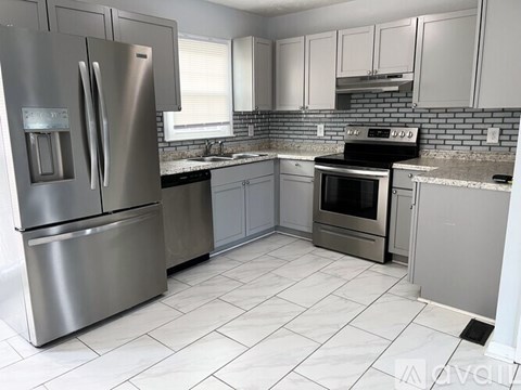 A kitchen with a stainless steel refrigerator and oven.