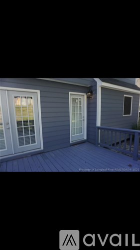 A house with a porch and a window is for sale.