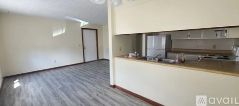 A kitchen area with a counter and a refrigerator.
