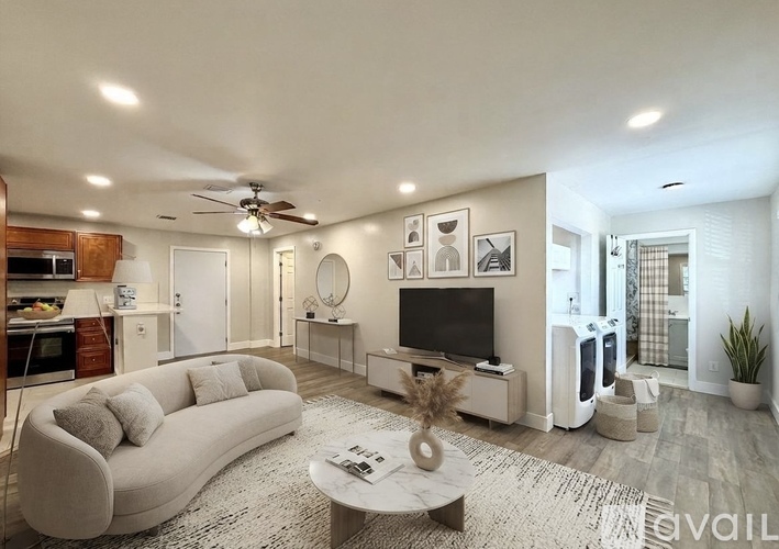 A living room with a white couch and a television.