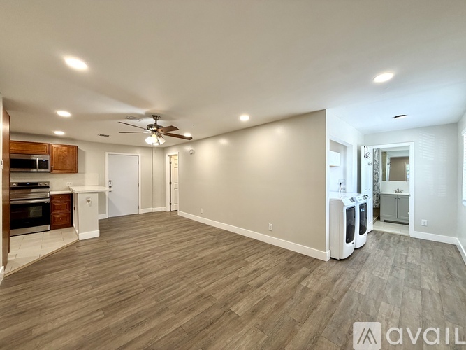 A spacious room with a ceiling fan and a wall-mounted air purifier.