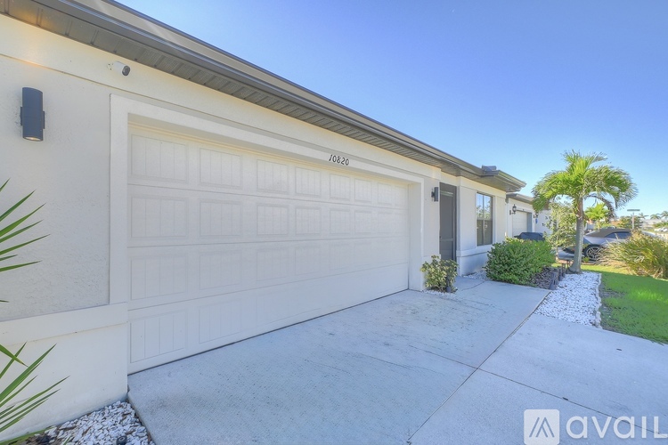 A house with a white garage door and the number 0242 on it.