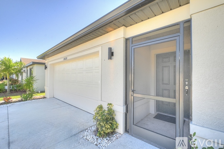 A modern house with a garage door and a glass door.