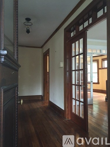 A room with wooden floors and a large mirror on the wall.