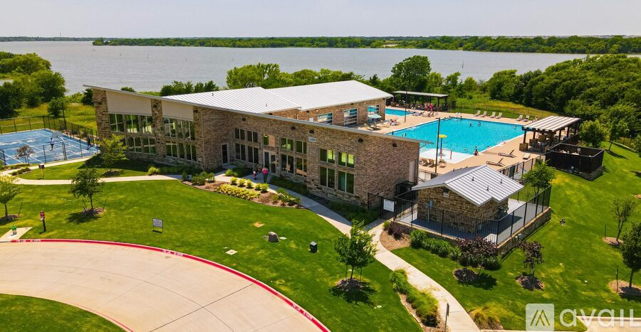 A large building with a pool in front of it.