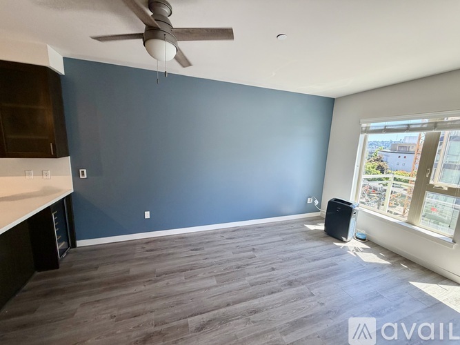 A room with a ceiling fan and a wall-mounted air conditioner unit.
