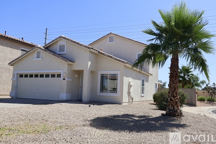 A house with a palm tree in front of it.