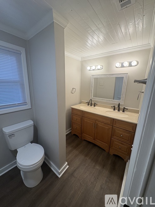 A white toilet sits next to a bathroom sink.
