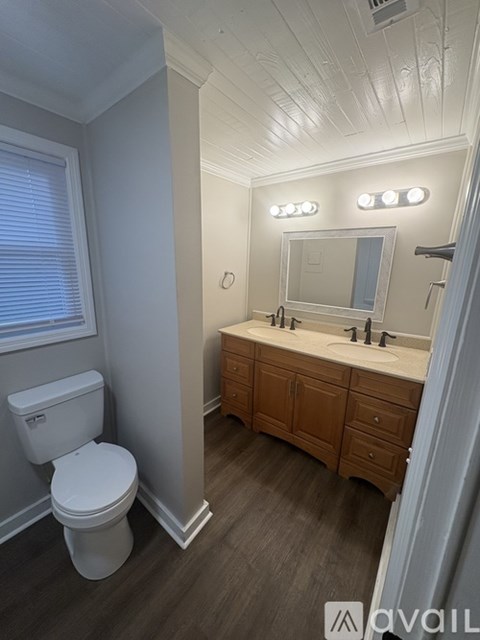 A white toilet sits next to a bathroom sink.