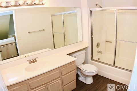 A bathroom with a sink, toilet, and shower.