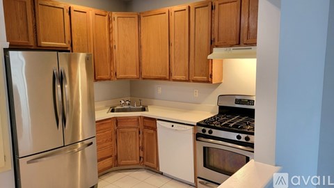 A kitchen with wooden cabinets and stainless steel appliances.