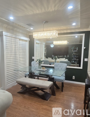 A dining room with a glass table and chairs.
