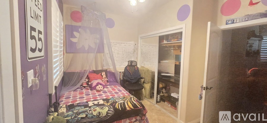 A bedroom with a bed and a purple wall with a sign that says 55.