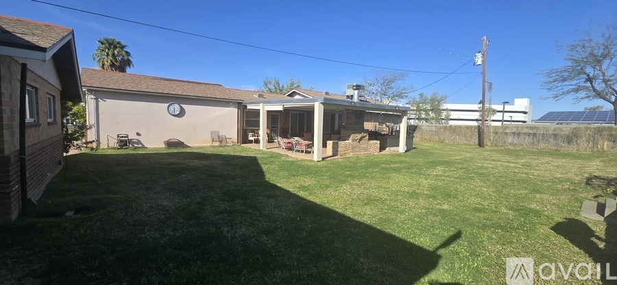 A backyard with a house and a gazebo.