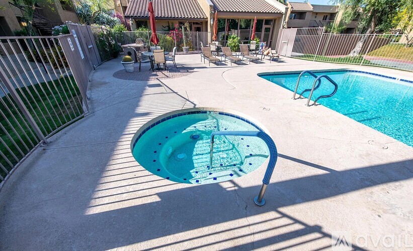 A small pool with a slide in the middle of a backyard.