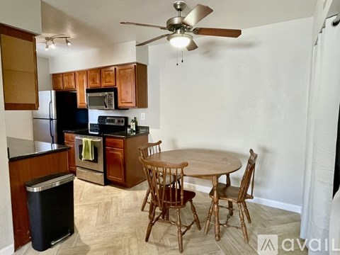 A kitchen with a table and chairs.