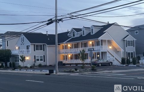 A row of houses with a car parked in front of the first one.