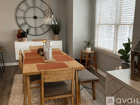 A dining room with a wooden table and chairs.