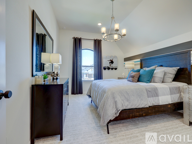 A bedroom with a large bed and a chandelier.