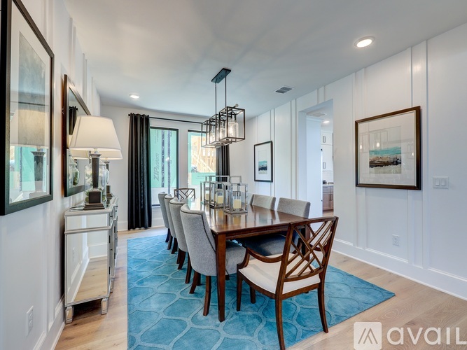 A dining room with a long table and chairs.