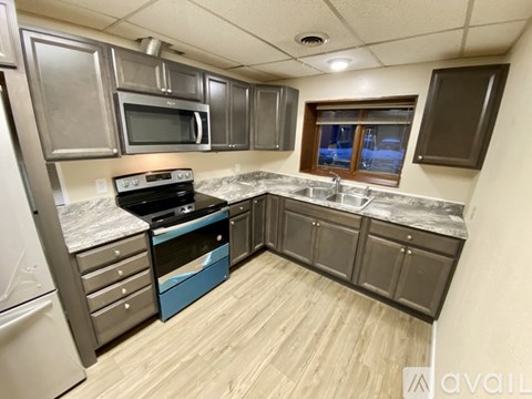A kitchen with a stove top oven and a sink.