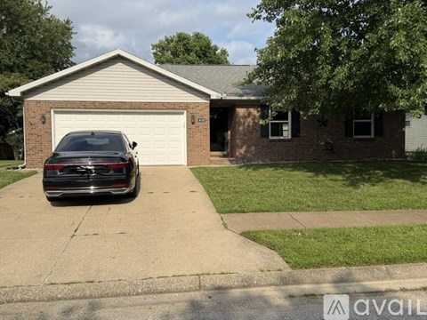 A black car is parked in front of a garage.