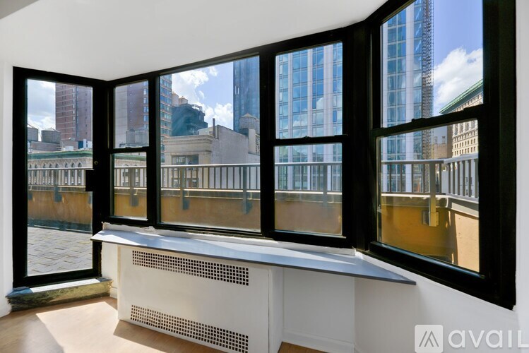 A room with a large window and a view of a cityscape.