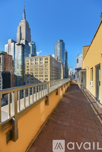 A balcony with a railing overlooks a cityscape.