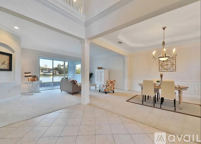 A spacious living room with a dining table set up in the middle.