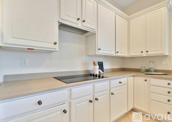 A kitchen with white cabinets and a countertop.