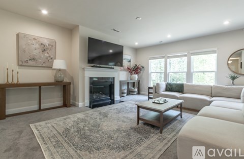 A living room with a fireplace and a large painting on the wall.
