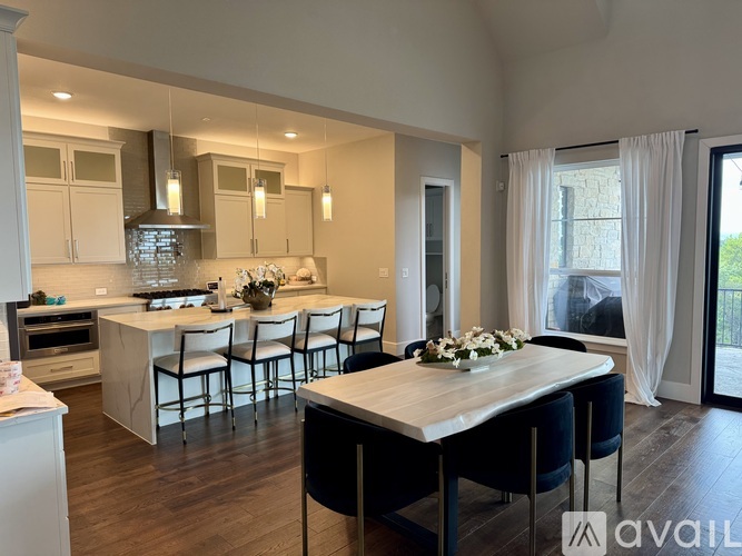 A modern kitchen with a dining table set for four.